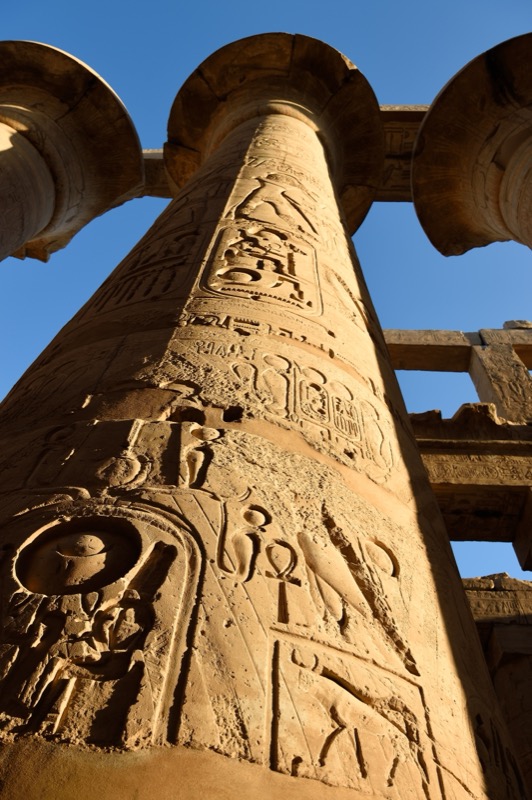 Karnak temple hypostyle hall with massive columns at sunrise